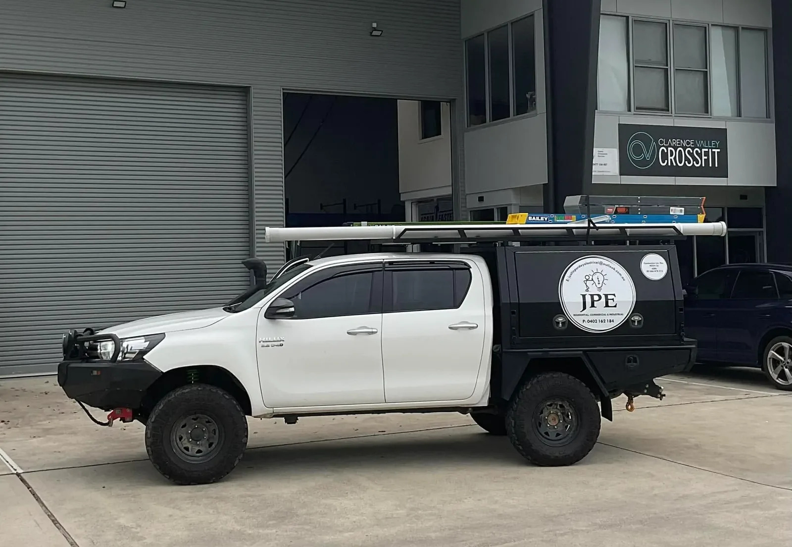 The Justin Purdey Electrical ute parked outside a commercial unit on a job