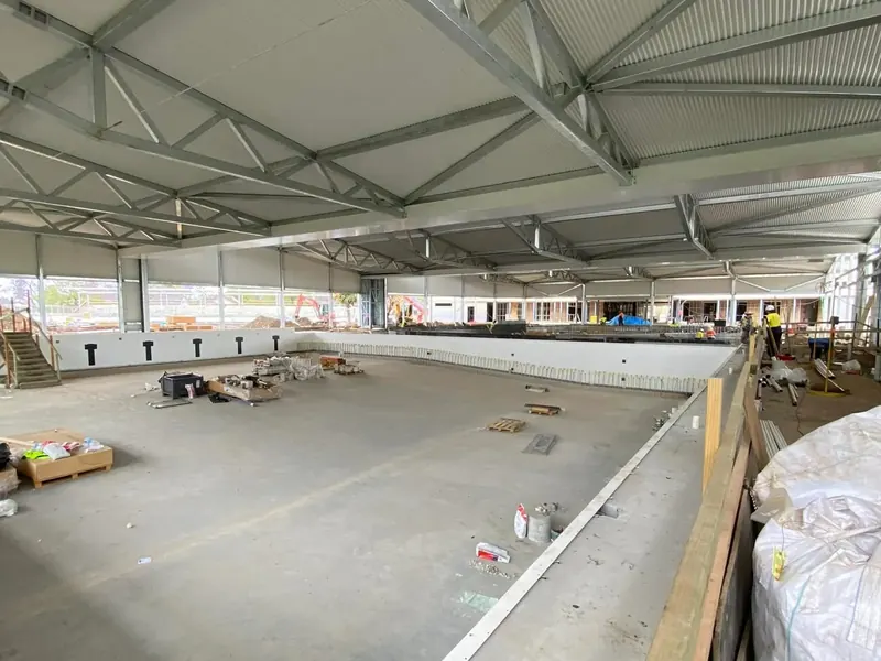 Interior of a large steel-framed shed with a concrete slab floor
